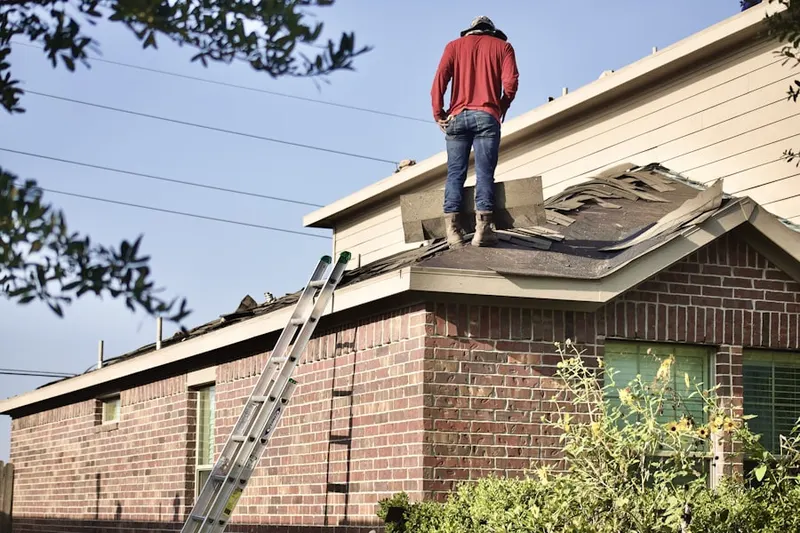 Professional roofer working on a residential roof in Turner